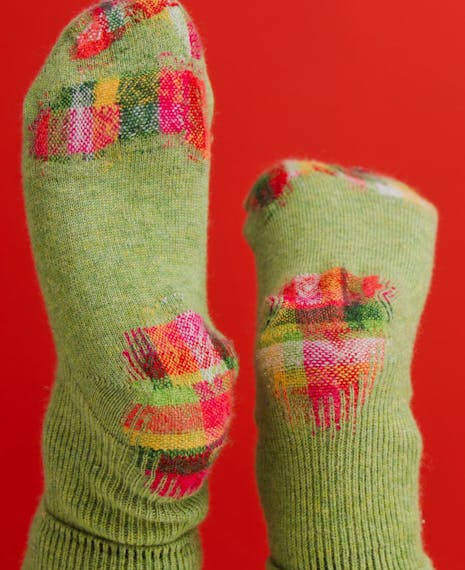 green socks darned in a beautiful creative pattern